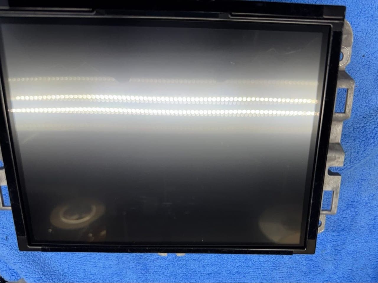 Repaired Uconnect display unit out of the vehicle before reinstallation